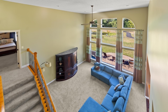 carpeted living room featuring ceiling fan