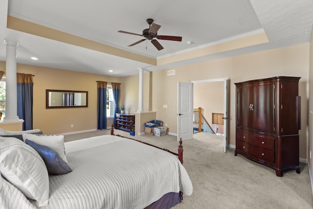 carpeted bedroom featuring ceiling fan, crown molding, and a tray ceiling