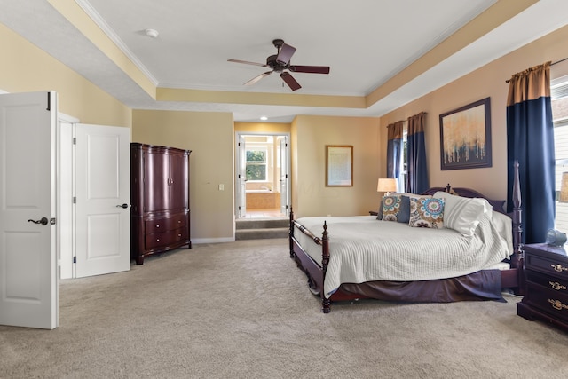 carpeted bedroom featuring a tray ceiling, ceiling fan, and crown molding