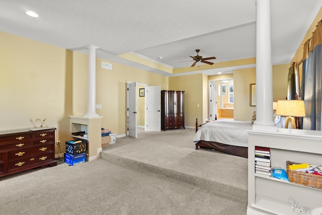 carpeted bedroom featuring ceiling fan, a raised ceiling, ornamental molding, and connected bathroom