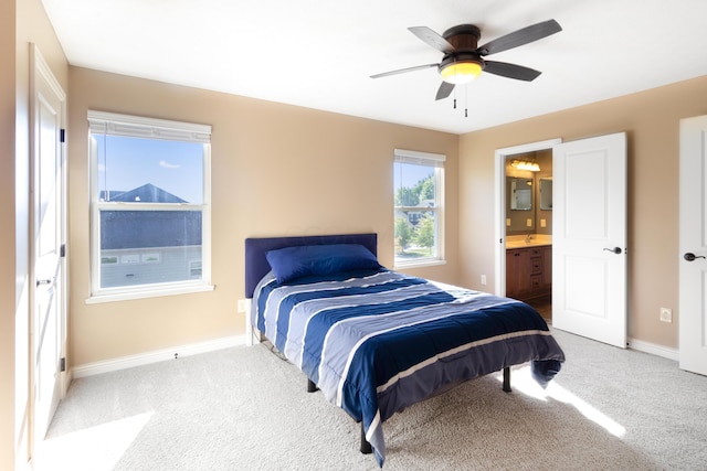 bedroom featuring carpet flooring, connected bathroom, and ceiling fan