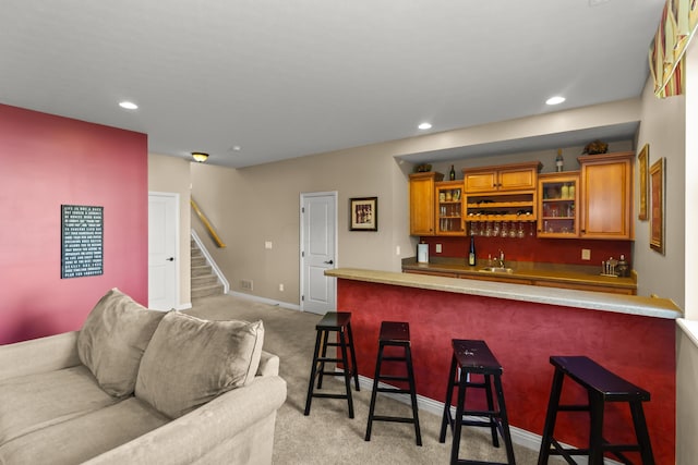 bar featuring light colored carpet and sink