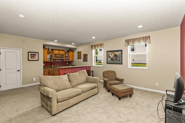 carpeted living room with bar