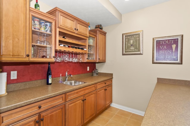 bar with sink and light tile patterned floors