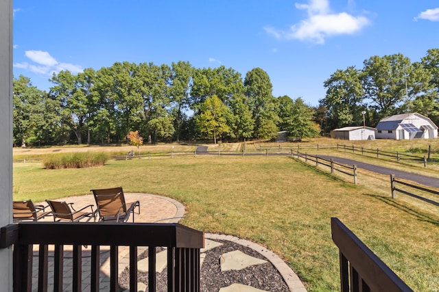 view of yard featuring a rural view and a patio