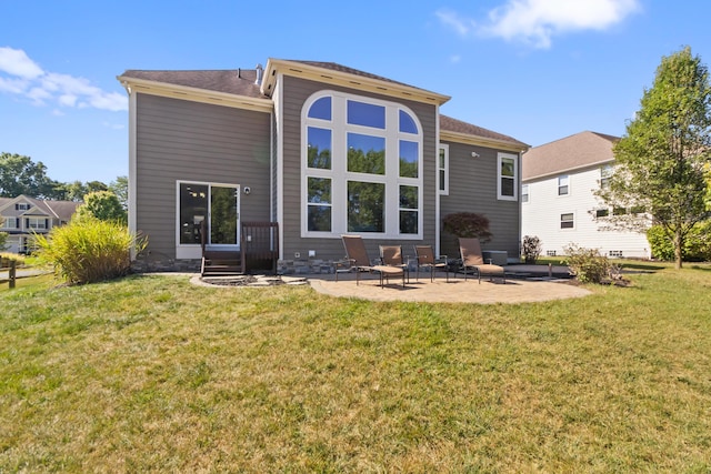 rear view of house with a patio area and a lawn