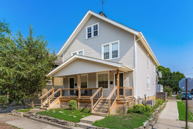 view of front of house with covered porch and central air condition unit