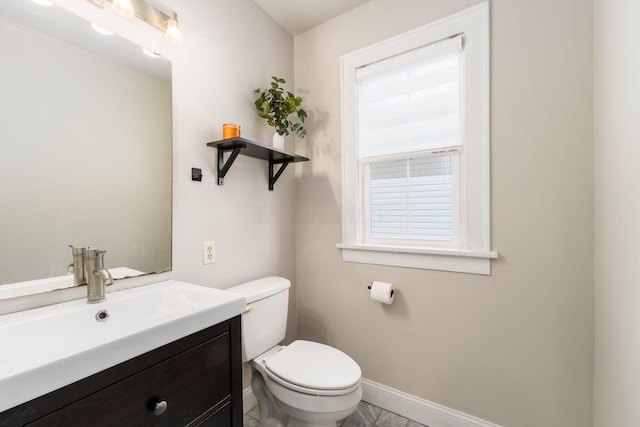 bathroom with tile patterned flooring, vanity, and toilet