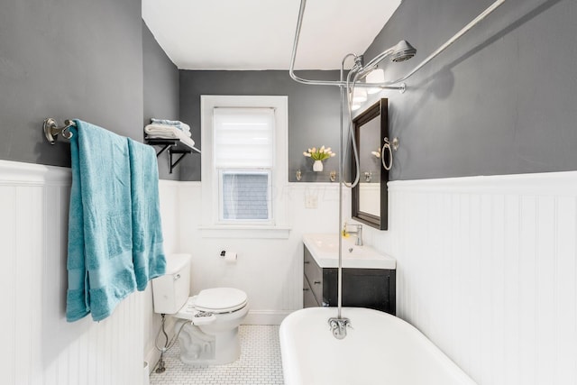 bathroom with tile patterned flooring, a bath, vanity, and toilet