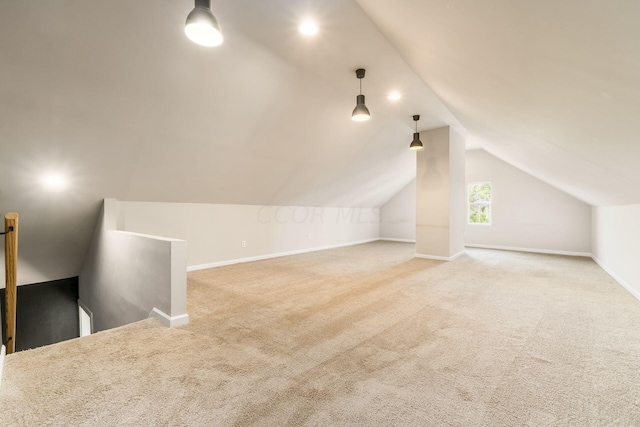 bonus room featuring carpet floors and vaulted ceiling