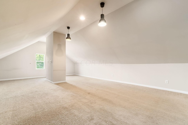 bonus room with light colored carpet and lofted ceiling