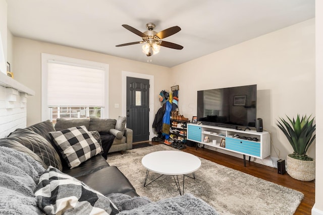 living room with dark hardwood / wood-style floors and ceiling fan