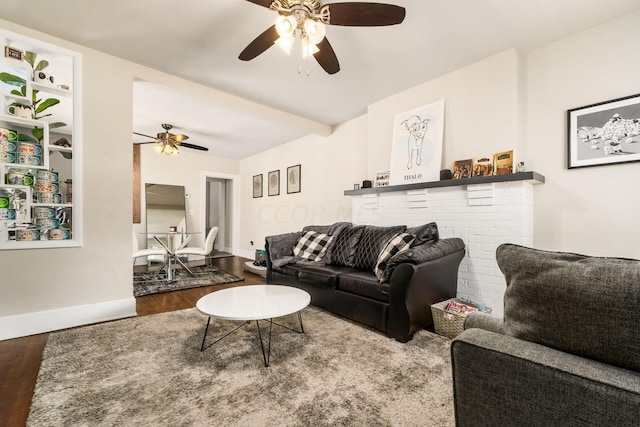 living room featuring hardwood / wood-style flooring, a brick fireplace, and ceiling fan