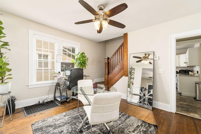 living area featuring hardwood / wood-style floors and ceiling fan