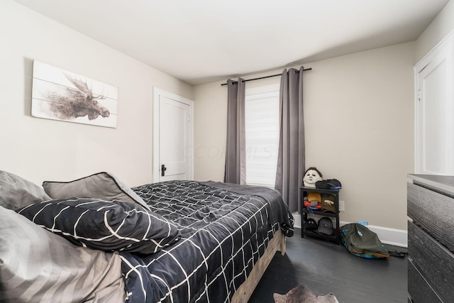 bedroom with dark hardwood / wood-style flooring