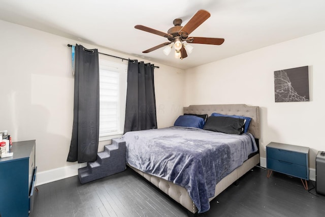 bedroom featuring dark hardwood / wood-style flooring and ceiling fan