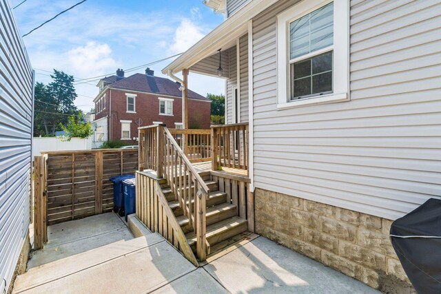 wooden terrace featuring a grill