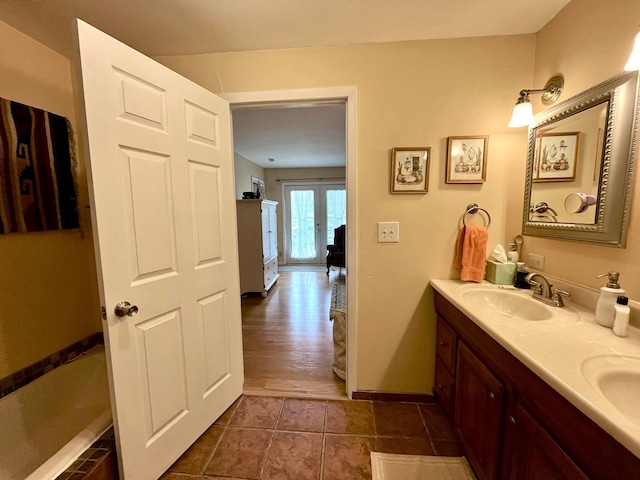 bathroom featuring vanity, wood-type flooring, and french doors