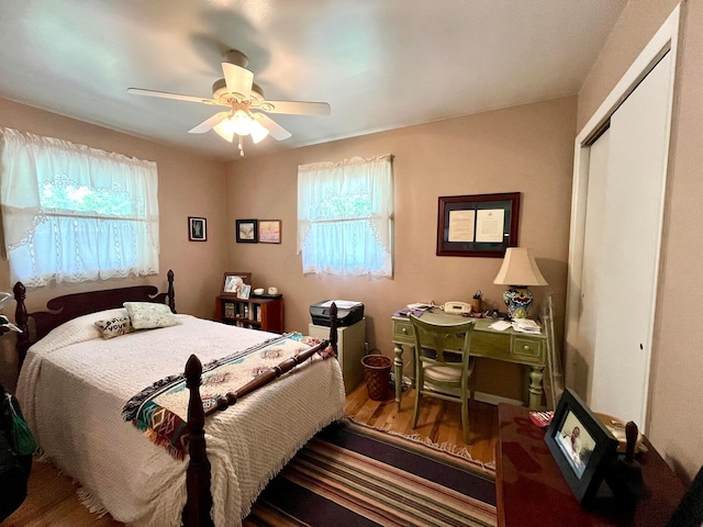 bedroom featuring ceiling fan, wood-type flooring, and a closet