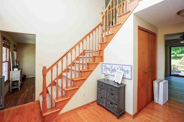 stairway with hardwood / wood-style floors, a textured ceiling, and radiator