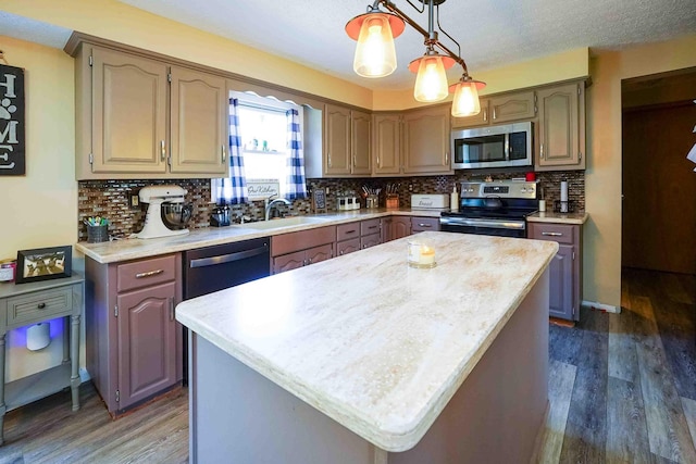 kitchen featuring tasteful backsplash, a kitchen island, dark hardwood / wood-style floors, and appliances with stainless steel finishes