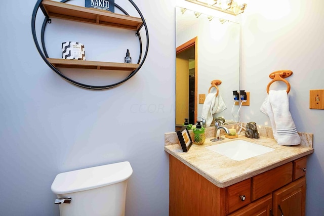 bathroom featuring vanity and toilet