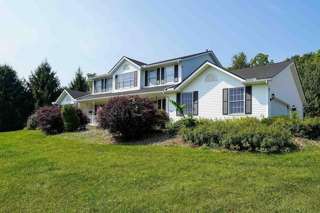 view of front facade with a garage and a front lawn