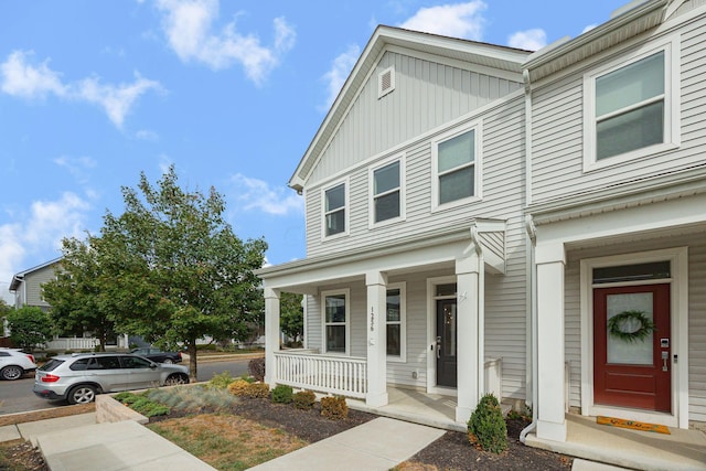 townhome / multi-family property featuring a porch