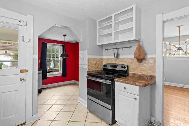 kitchen featuring white cabinetry, a textured ceiling, decorative light fixtures, electric stove, and decorative backsplash