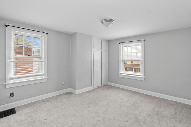 unfurnished bedroom with light carpet