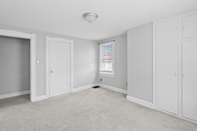 unfurnished bedroom with light colored carpet