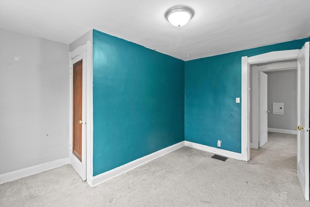 empty room featuring light colored carpet