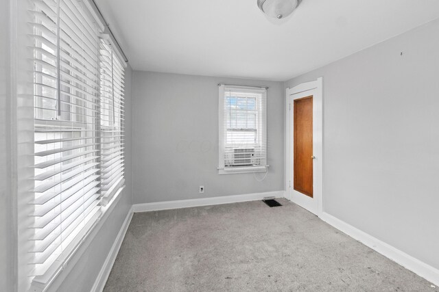 empty room featuring light colored carpet