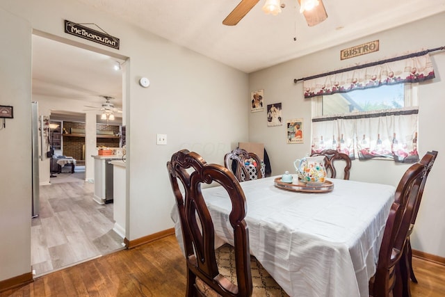 dining space featuring ceiling fan and wood-type flooring