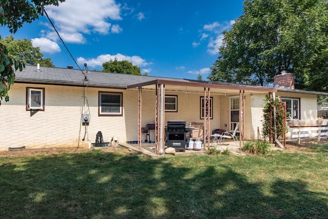 rear view of property with a patio area and a yard