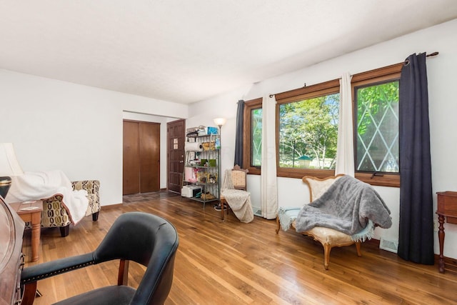 sitting room with hardwood / wood-style flooring