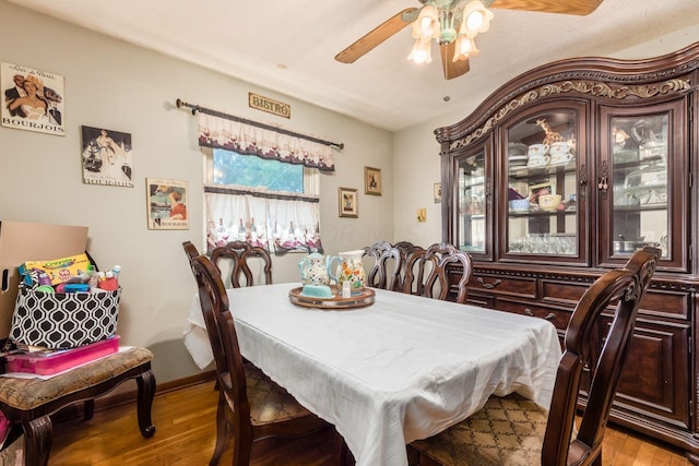 dining space with ceiling fan and light hardwood / wood-style floors