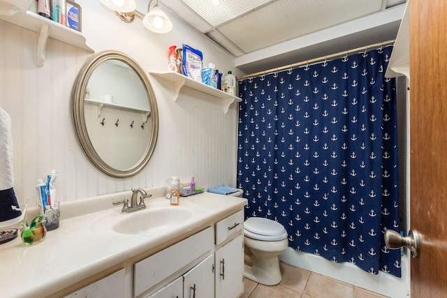 bathroom featuring toilet, vanity, tile patterned floors, and walk in shower