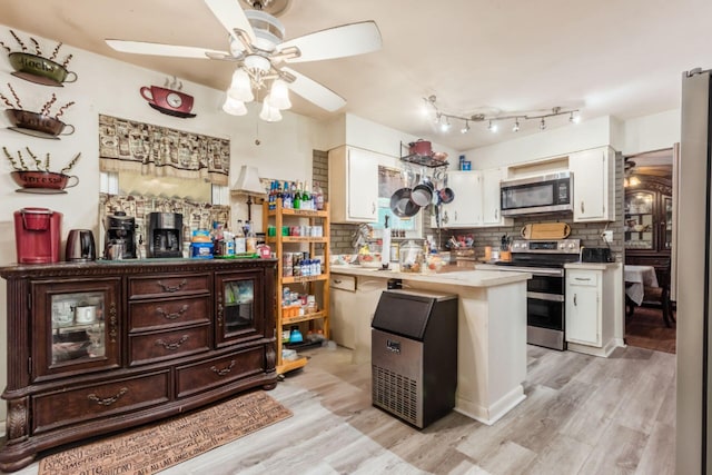 kitchen featuring white cabinets, ceiling fan, appliances with stainless steel finishes, tasteful backsplash, and light hardwood / wood-style floors