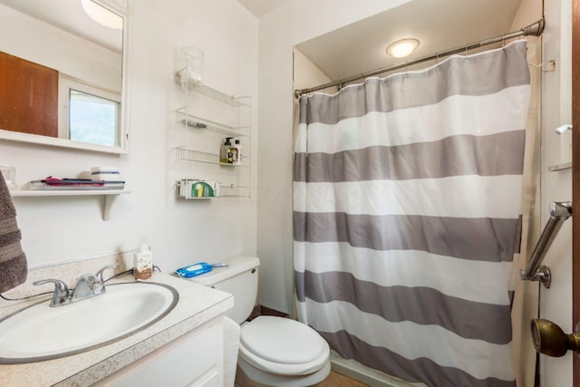 bathroom with vanity, toilet, and curtained shower