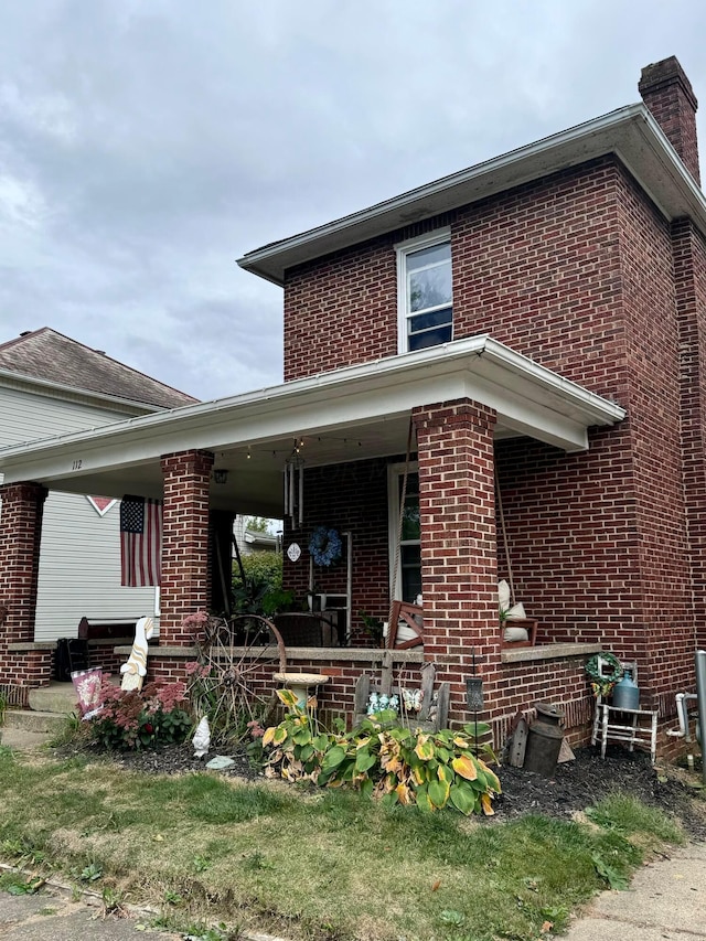 back of house featuring covered porch