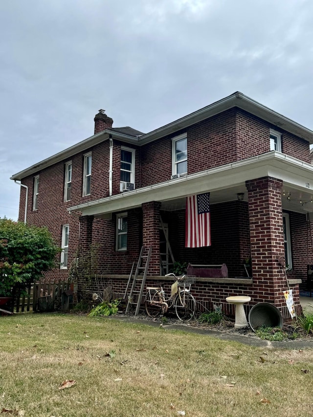 exterior space featuring a porch and a lawn