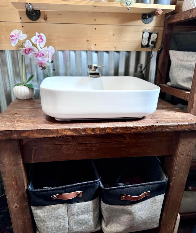 bathroom with wood walls and sink