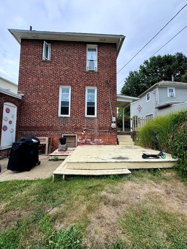 rear view of property featuring a wooden deck