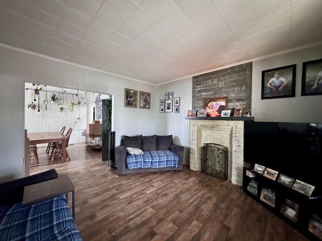 living room featuring a fireplace, wood-type flooring, and crown molding