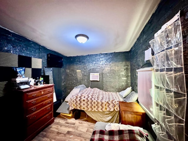 bedroom with light wood-type flooring and vaulted ceiling