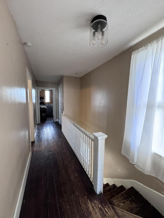 hall with dark wood-type flooring