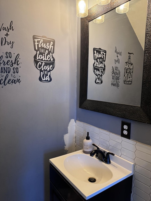 bathroom featuring decorative backsplash and vanity