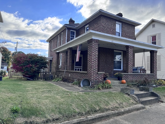 view of front of home with covered porch and a front lawn