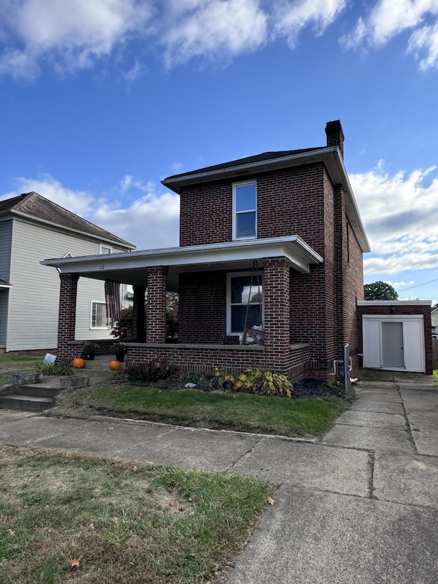 view of front of property featuring a shed